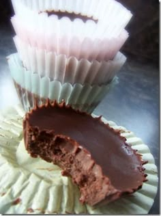 two chocolate cups with one half eaten and the other half partially covered in frosting