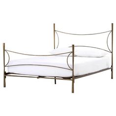 a metal bed frame with white sheets and pillows on it's headboard, against a white background