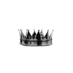 a black metal crown sitting on top of a white surface