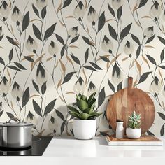 a kitchen counter with two pots and a cutting board