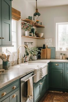 a kitchen filled with lots of green cabinets and white counter tops, next to a window