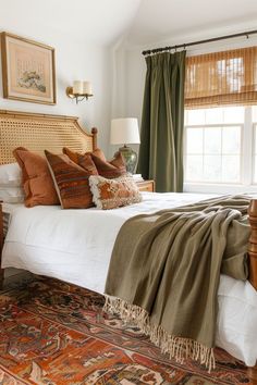 a bedroom with a large bed and green curtains