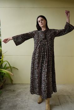 Late 60's, early 70's bell sleeved maxi dress in leopard print. Back zipper to close.  Bust: 40" Hips: 60" Length: 54" Circa: 1970's Condition: Fair vintage condition. This one was a labor of love. I had it re-hemmed and had stitching removed from the bust area (barely visible holes remain, but you have to look carefully). There are bleach spots throughout that kind of ate into the fabric (especially on the ends of the sleeves) and  scattered holes throughout. One sleeve is slightly longer than Dress Loungewear, Sleeved Maxi Dress, Dress Bell Sleeve, Hostess Dresses, Leopard Print Maxi Dress, Dress Vacation, Haute Hippie, Vacation Dresses, Maxi Dress With Sleeves