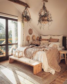 a bed room with a neatly made bed and two hanging plants