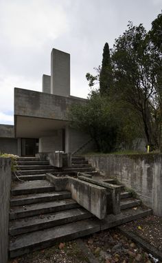 an abandoned concrete building with stairs leading up to it