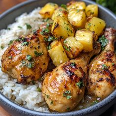 a bowl filled with chicken and pineapples on top of rice