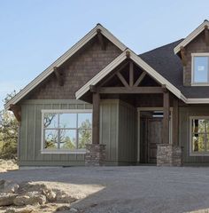 a large house with two windows and stone pillars