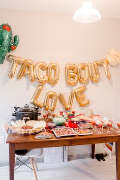 taco bout love balloons and food on a table