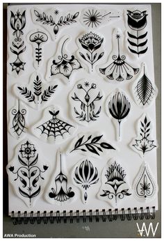 a sheet of black and white stamps with different designs on it, including flowers and leaves