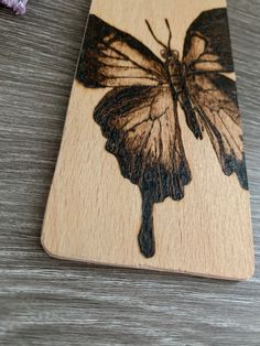 a butterfly is shown on a wooden cutting board