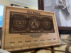 a wooden plaque with the words ave maria on it