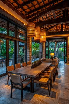 a large wooden table sitting inside of a living room next to a glass wall door