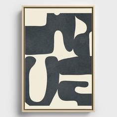 a black and white abstract art piece hanging on a wall in front of a wooden frame