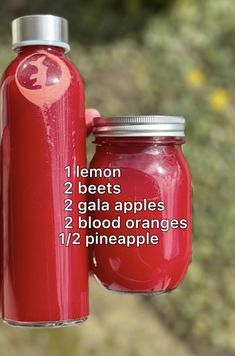 a hand holding a red glass bottle with instructions on how to use it