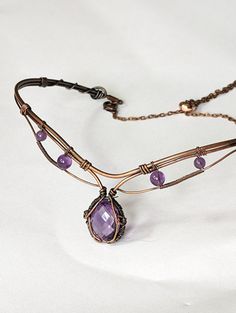 Enhance your look with this stunning 6ct Amethyst choker in copper! Handcrafted with quality materials, this choker features a beautiful Amethyst gemstone in the center, set in copper wire wrap that creates a beautiful and eye-catching design. The copper wire wrap is intricately detailed and flows gracefully around the gemstone, giving it an elegant feel. The choker fits comfortably around the neck and is lightweight enough to be worn all day. You'll be sure to make a bold statement with this un Wire Wrapped Choker Tutorial, Wire Wrap Choker, Wire Wrapped Choker, Wire Necklace Diy, Amethyst Choker, Wire Choker Necklace, Wire Choker, Wire Pendants, Wire Jewellery