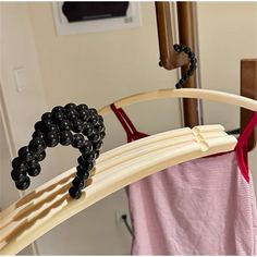 a wooden rack with black beads hanging from it