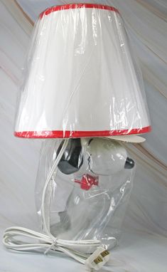 a lamp that is wrapped in plastic and has a red stripe on the bottom part