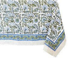 a blue and green table cloth with flowers on the border, in front of a white background