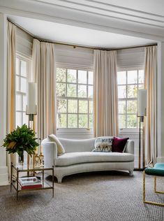 a living room filled with furniture and windows