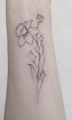 a small flower tattoo on the wrist