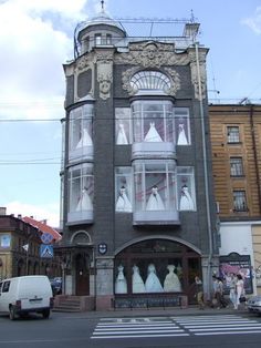 an old building with mannequins on the windows