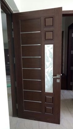 the door is made of wood and has frosted glass panels on each paneling