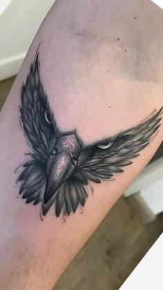 a black and white bird tattoo on the leg