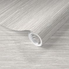 a white wallpaper with wavy lines on the top and bottom, as well as a roll of tape