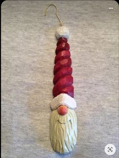 a christmas ornament with a santa hat and beard