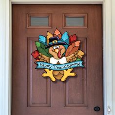 a happy thanksgiving turkey door hanger on a front door