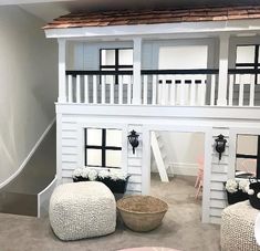 a doll house with white walls and black trim on the top floor is shown in this photo