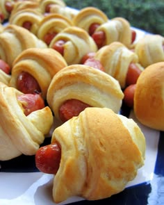 hot dogs wrapped in crescent rolls on a plate