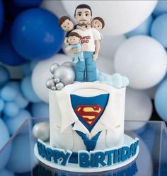 a birthday cake with a superman figure on top