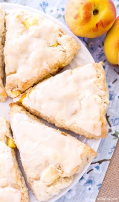 slices of scones with icing on a plate next to peaches