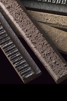 several different types of bricks sitting next to each other on top of a black surface