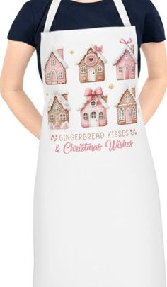 a woman wearing an apron with gingerbread kisses and christmas wishes printed on the front