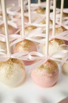 cake pops with pink and gold glitter on them