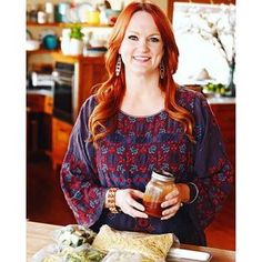 a woman holding a jar of food in her hands