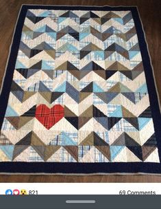 a quilt with a red heart on it