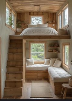 there is a loft bed in the middle of this room with stairs leading up to it