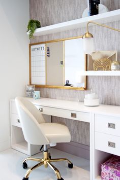 a white desk with a gold framed mirror above it and a chair next to it