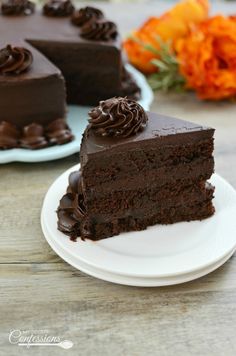 there is a piece of chocolate cake on the plate and another slice has been cut