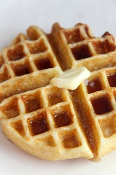 waffles with syrup and butter on a white plate