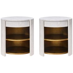 two white marble side tables with gold trimmings on each end and one shelf in the middle