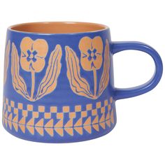 a blue and yellow coffee mug with flowers on it