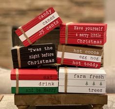 a stack of christmas books sitting on top of a table