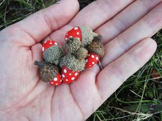 small stuffed animals are sitting in the palm of someone's hand