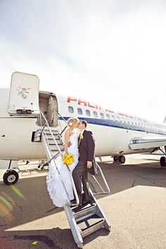 a newly married couple getting off an airplane