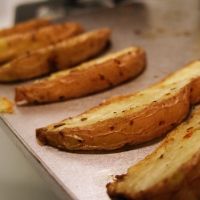 baked french fries are lined up on a baking sheet