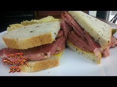 a roast beef sandwich cut in half on a plate